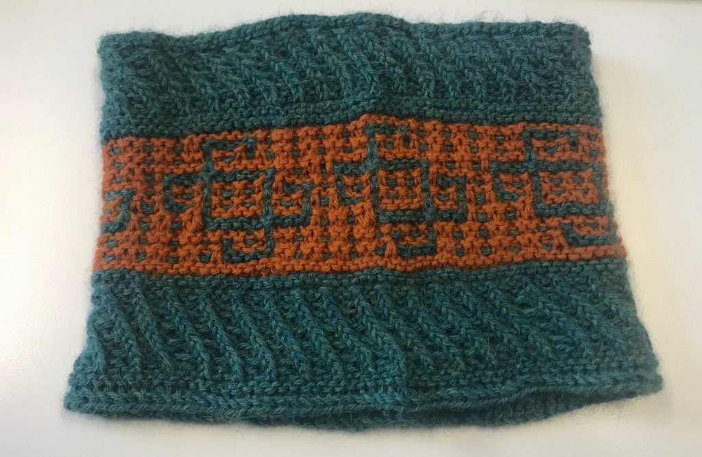 A photograph showing a finished knitted CHI 2019 cowl.